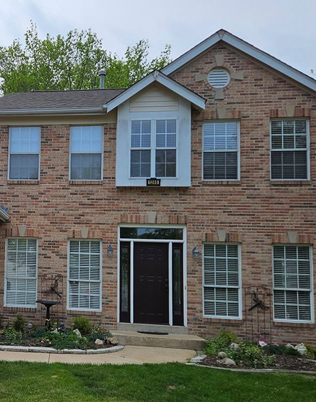 Brick colonial home exterior before painting, natural brick